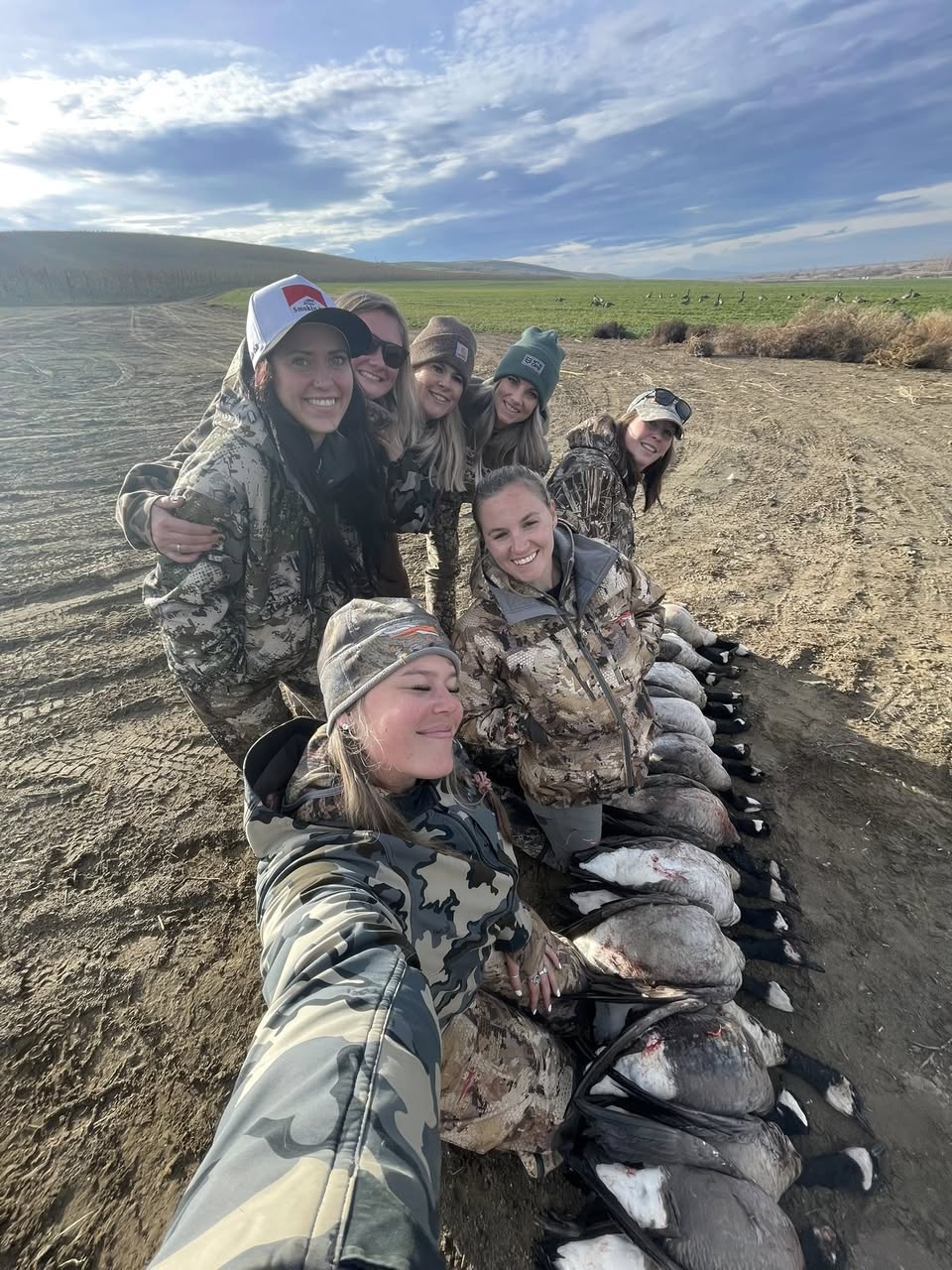 A group of women hunters with their line of Canada geese